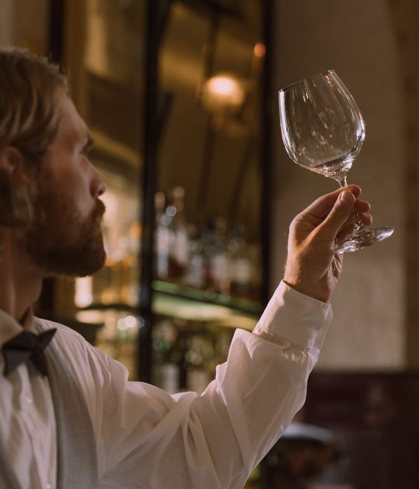 Professional portrait of Mateo Diaz, Sommelier, holding a wine glass
